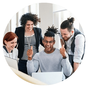 A group of people standing around a laptop.