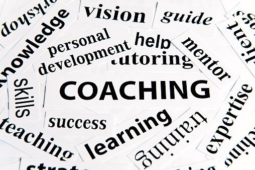 A close up of the word coaching written in many different words