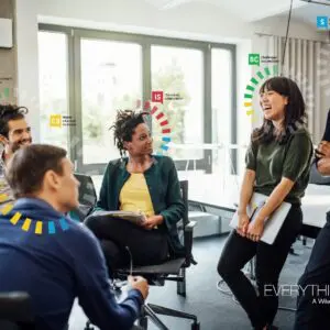 A Group Of People Talking And Laughing